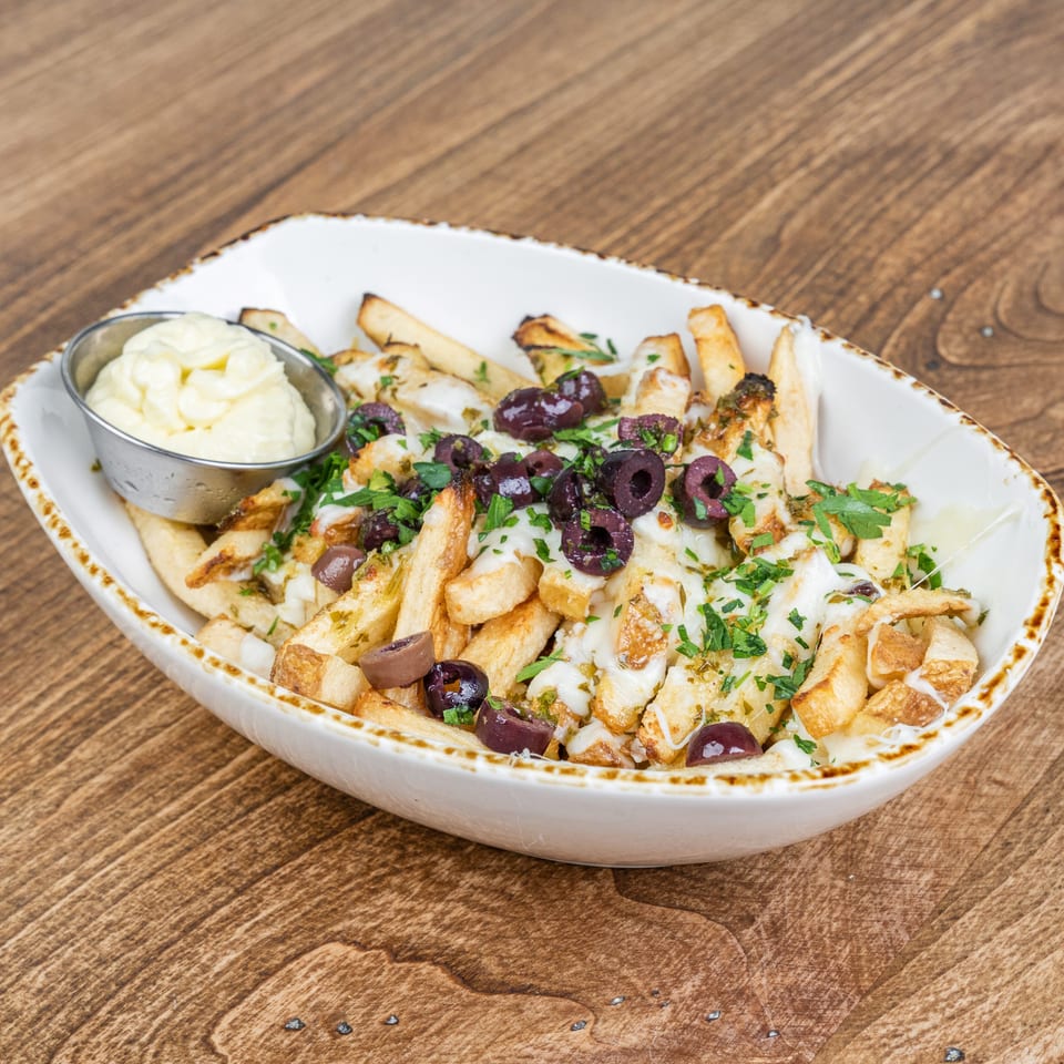 Loaded fries topped with grilled chicken, melted cheese, sliced olives, fresh herbs, and garlic sauce, served with mayonnaise.
